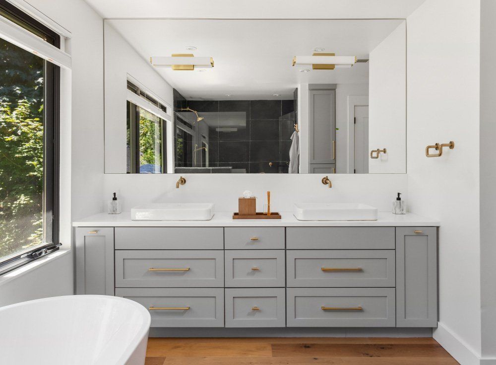 A Bathroom with Two Sinks, a Tub and A Large Mirror— Origin Plumbing & Gas in Tuckurimba, NS