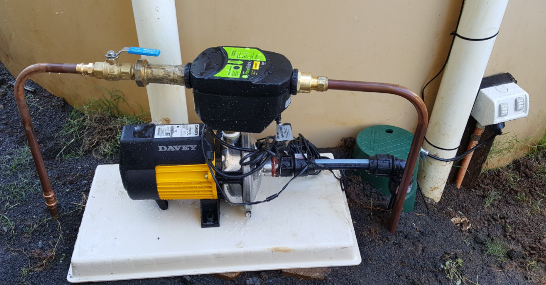 A Water Pump Is Sitting on Top of A White Platform — Origin Plumbing & Gas in Tuckurimba, NSW