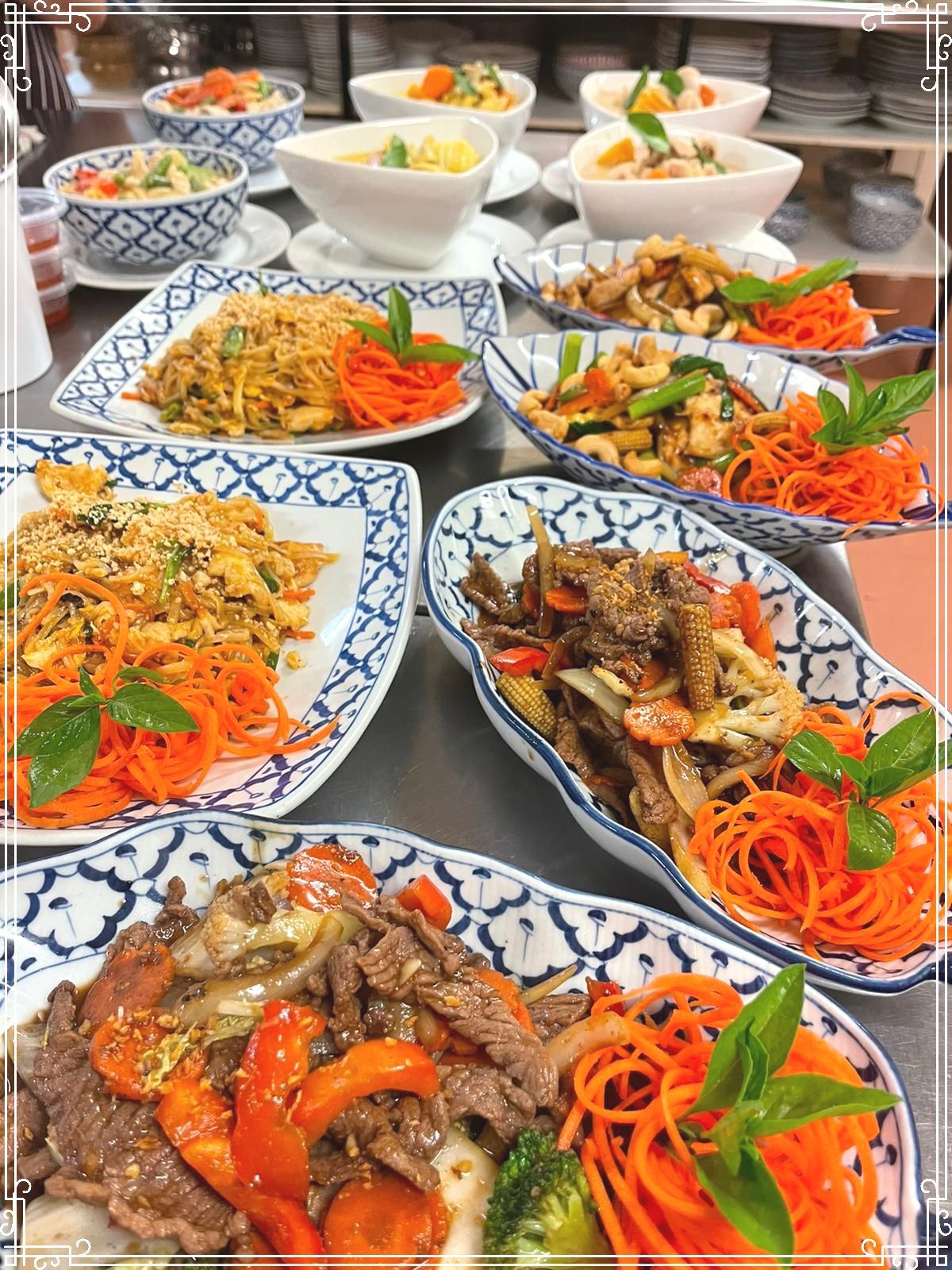A Table Topped With Plates of Food and Bowls of Food — Thai Taste Restaurant In Norman Gardens, QLD