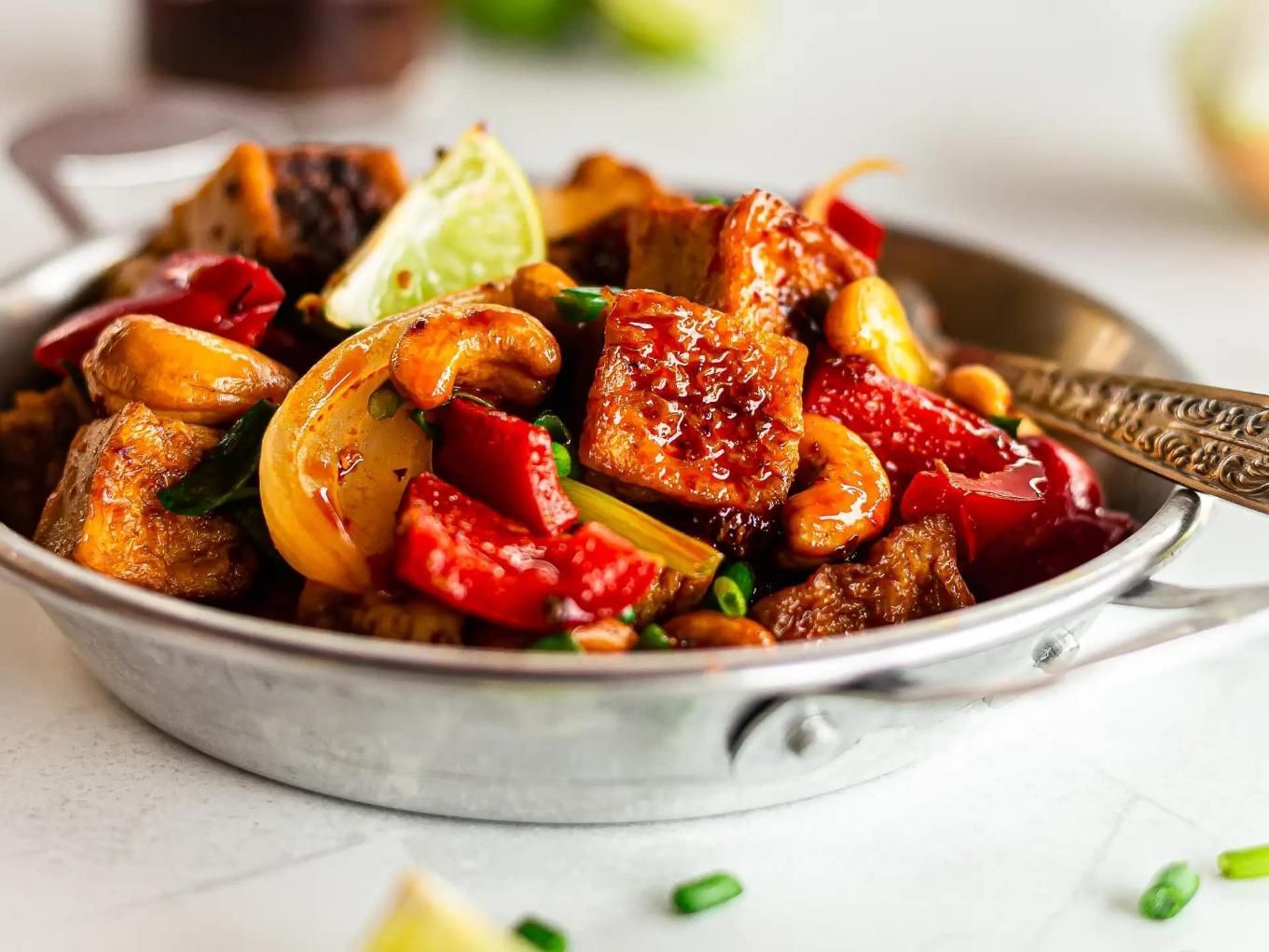 A Pan Filled With Vegetables and Meat With a Spoon in It — Thai Taste Restaurant In Norman Gardens, QLD