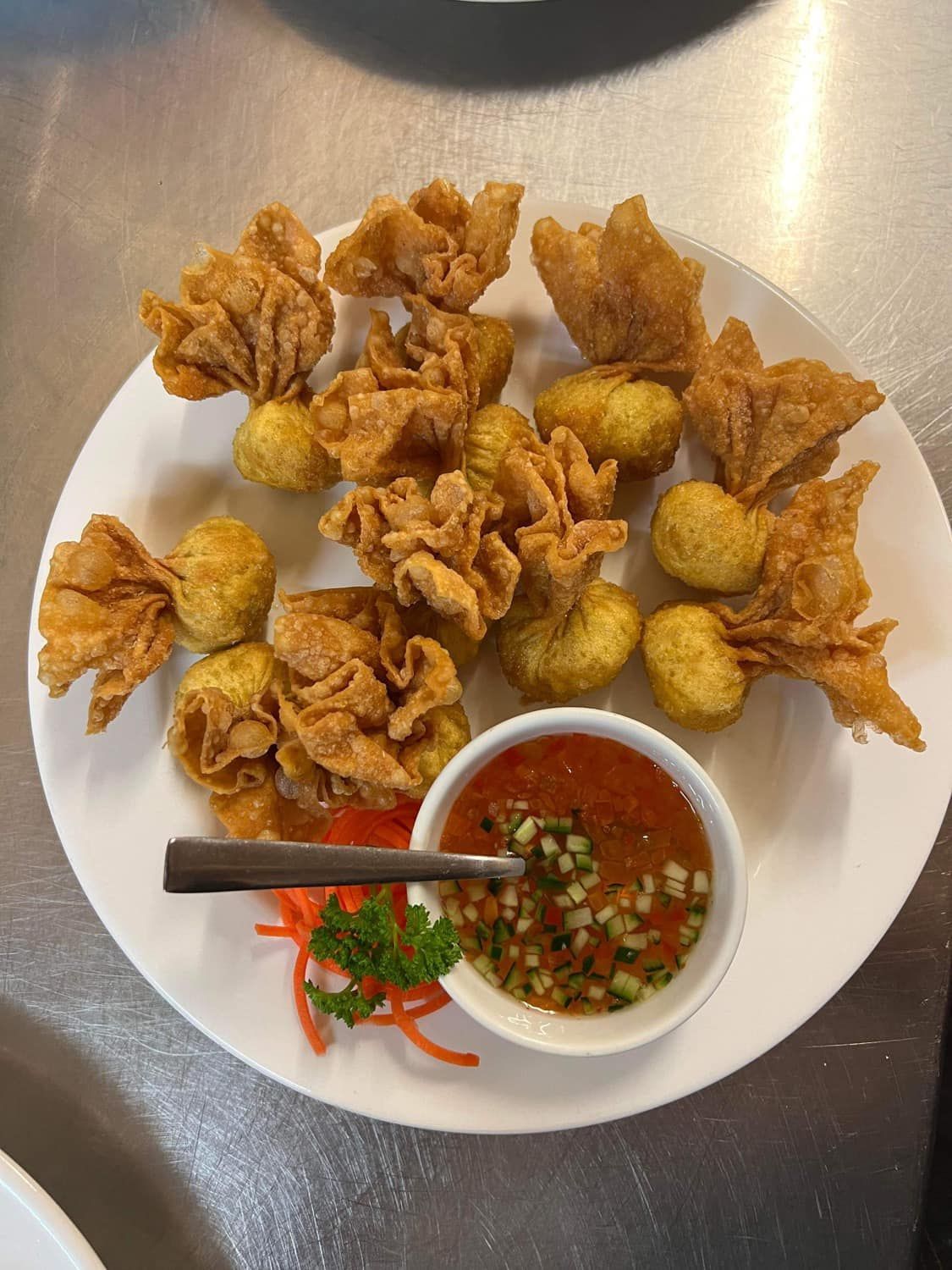 A White Plate Topped With Fried Food and a Bowl of Dipping Sauce — Thai Taste Restaurant In Norman Gardens, QLD