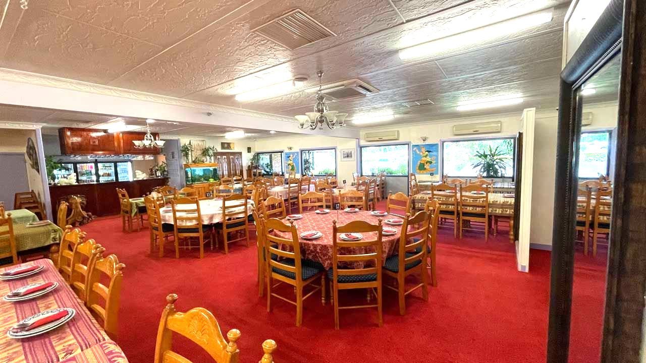 A Large Dining Room With Tables and Chairs and a Red Carpet — Thai Taste Restaurant In Norman Gardens, QLD