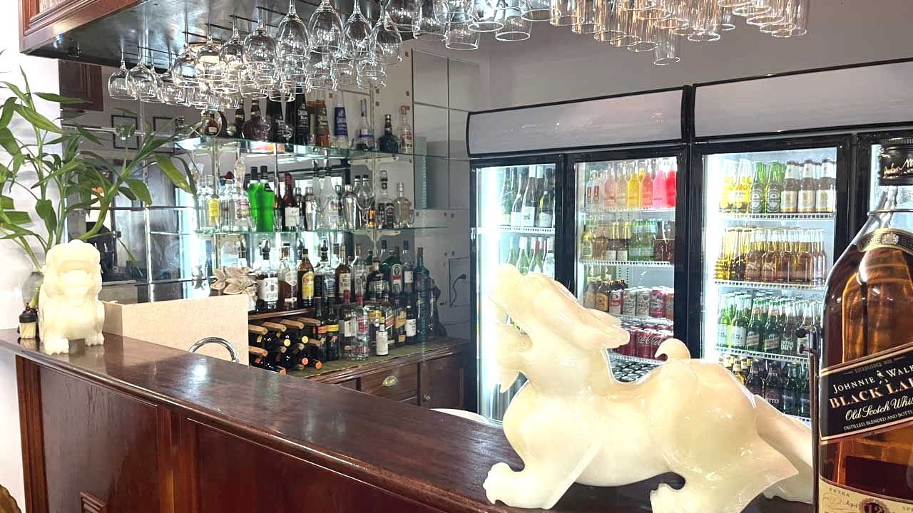 A Bar With a Statue of a Dragon on the Counter — Thai Taste Restaurant In Norman Gardens, QLD