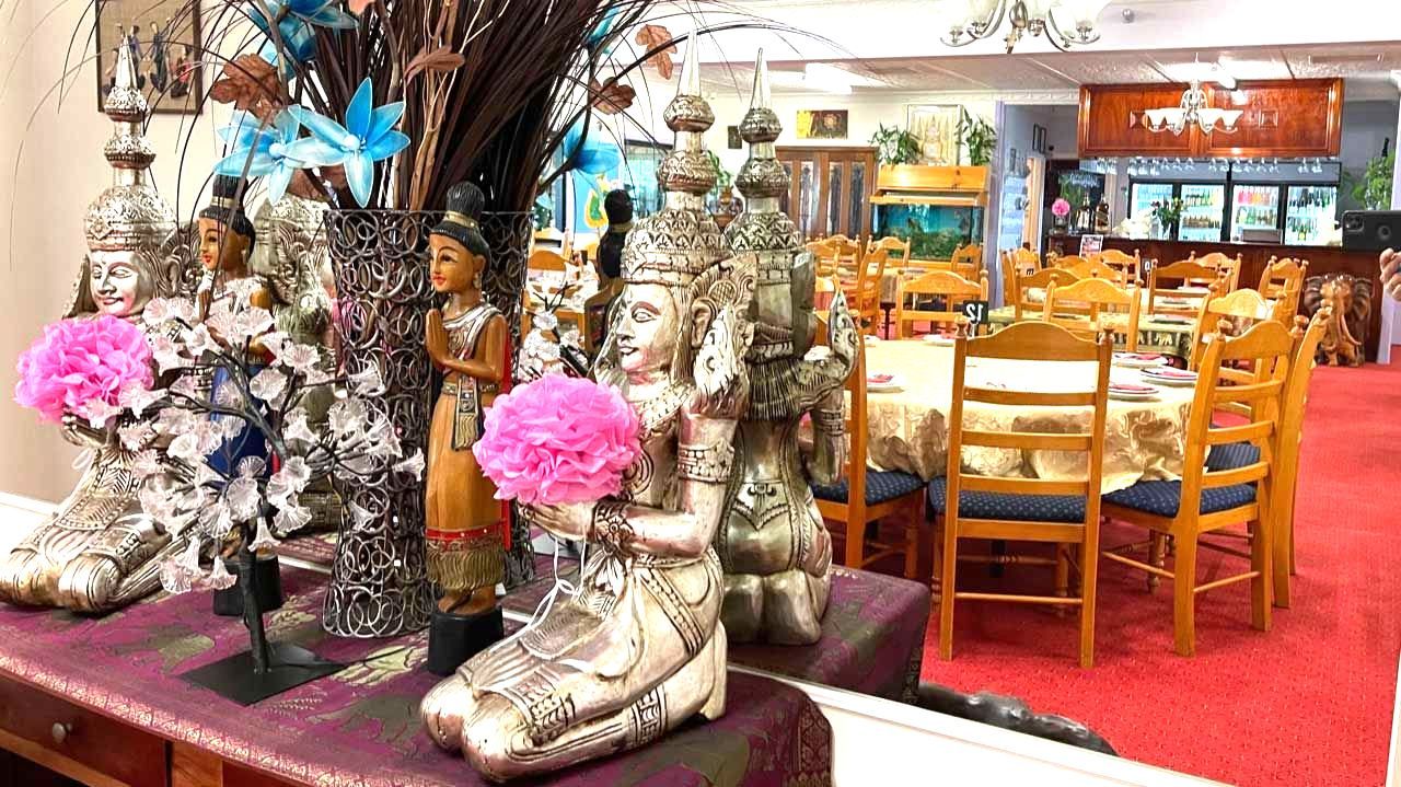 A Group of Statues Sitting on Top of a Table in a Restaurant — Thai Taste Restaurant In Norman Gardens, QLD