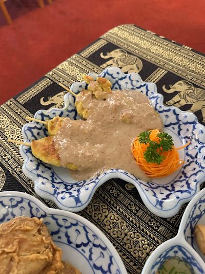 A Plate of Food With Sauce and Carrots on a Table — Thai Taste Restaurant In Gracemere, QLD