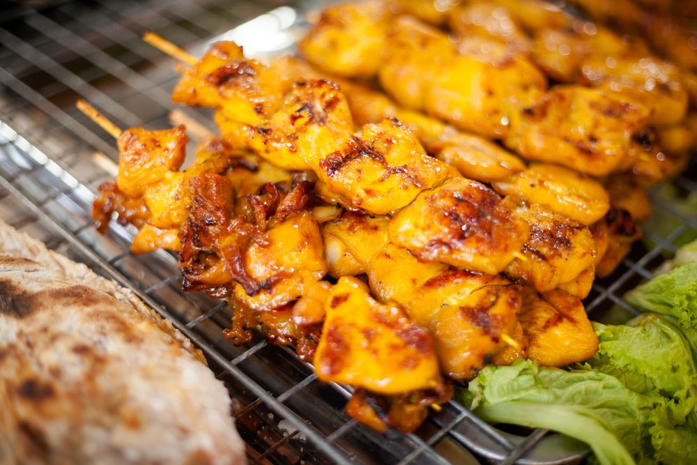 A Close Up of Chicken Skewers on a Grill — Thai Taste Restaurant In Norman Gardens, QLD