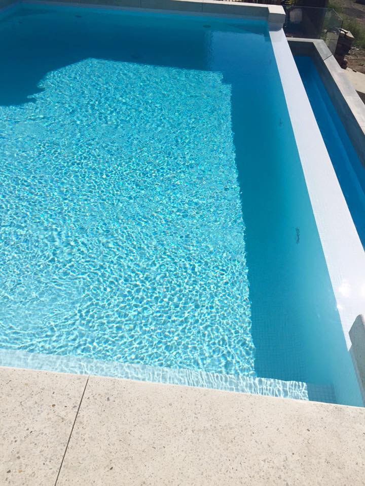 View of a pool with concrete surrounding