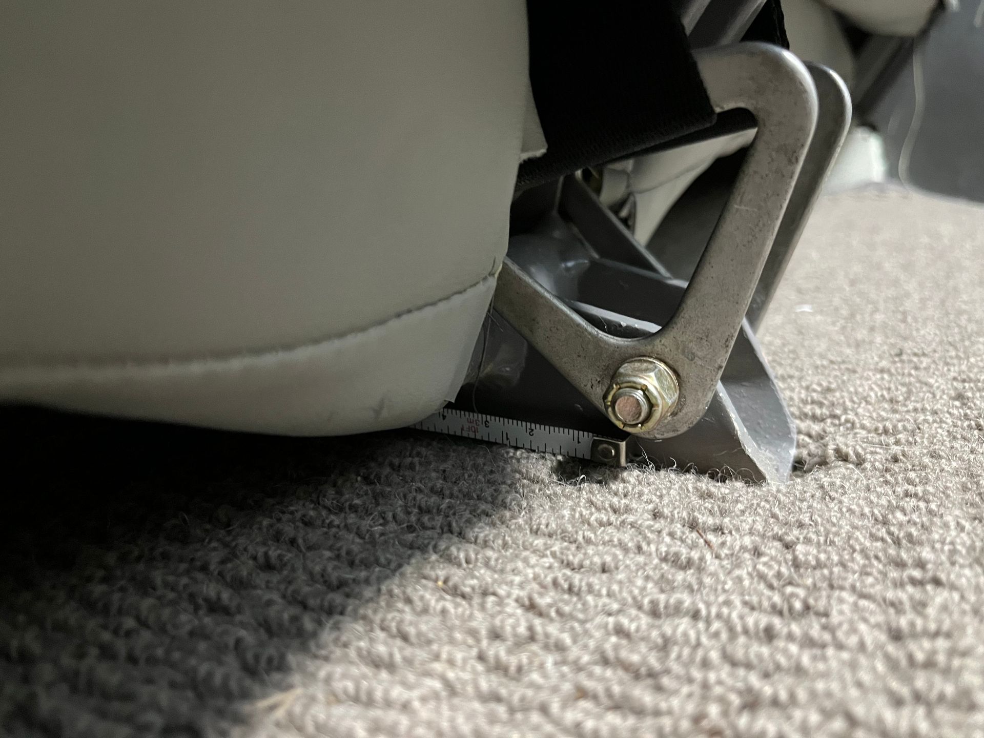 A close up of a foot rest on a carpeted floor.