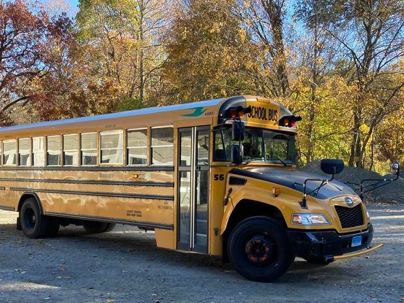 A yellow school bus is parked in a parking lot