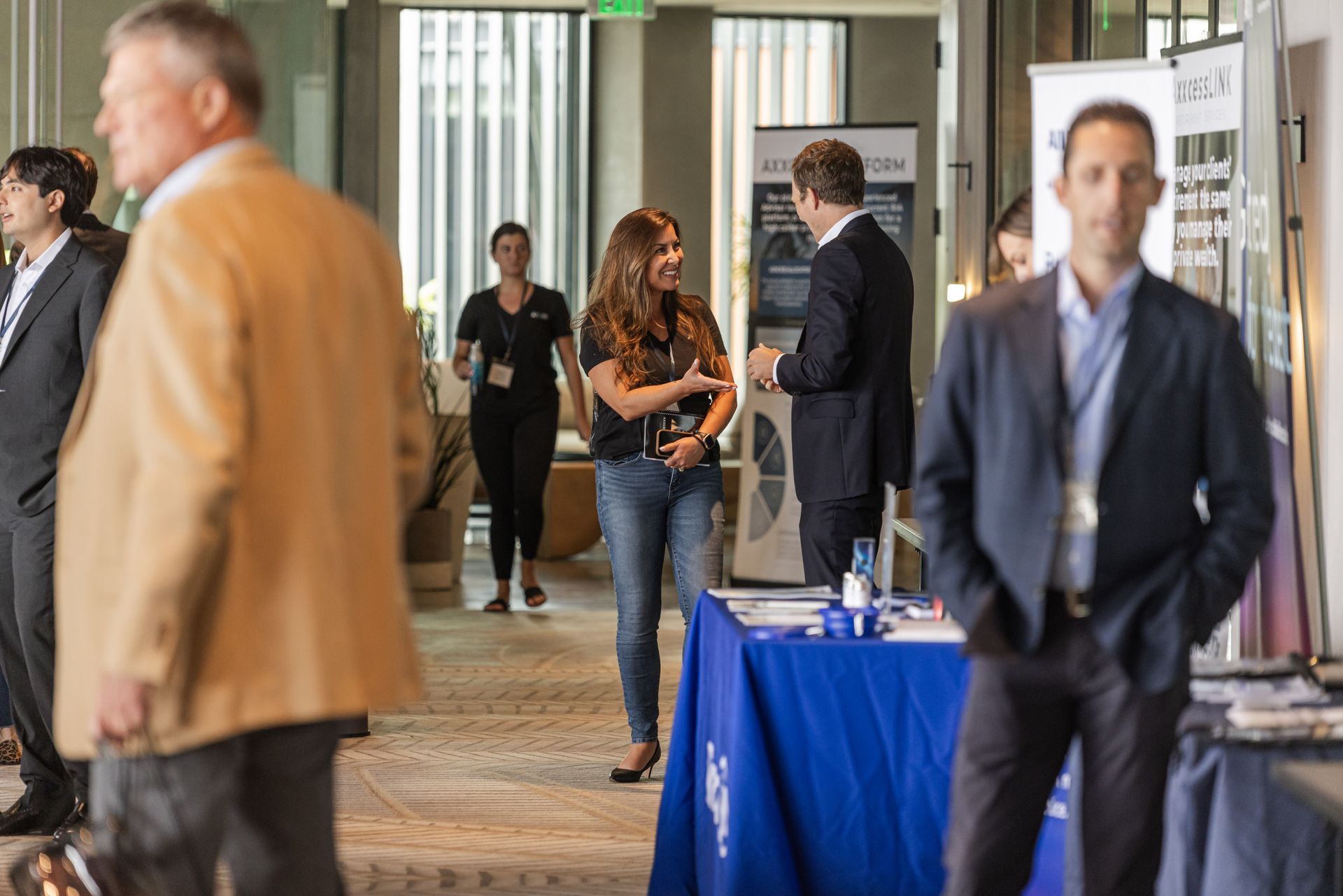 A group of people are standing around a table at a conference.