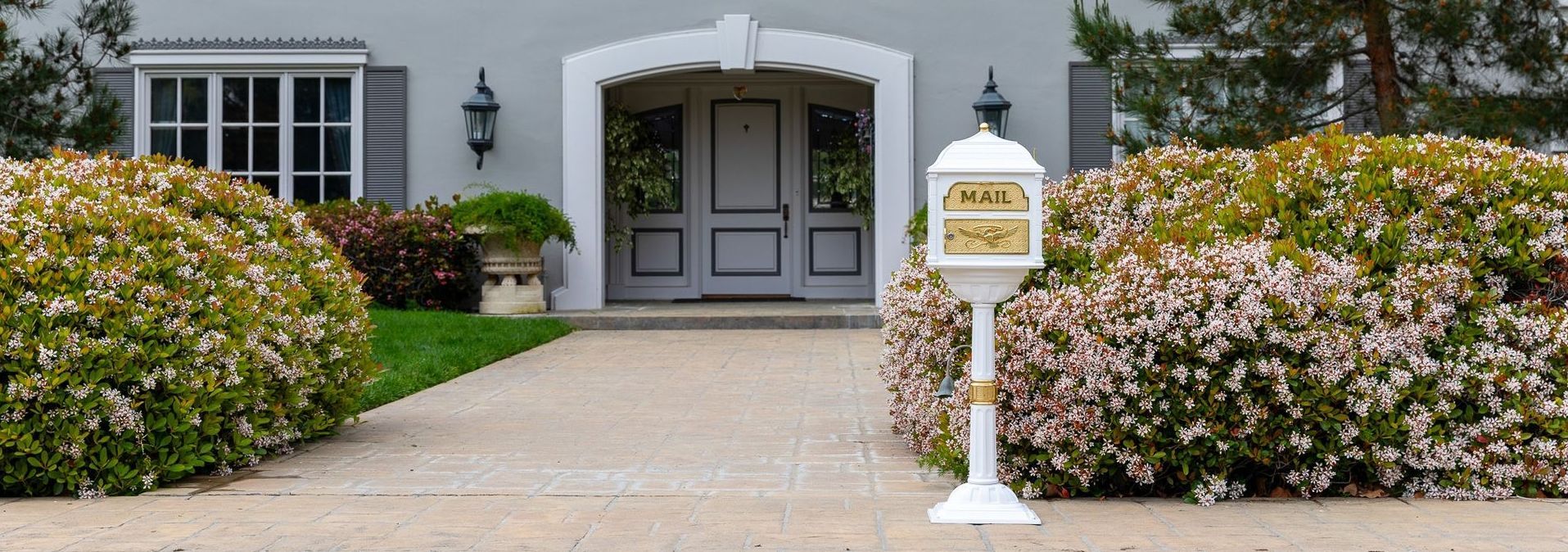 Gaines mailbox installed in a residential front yard, shown in natural light