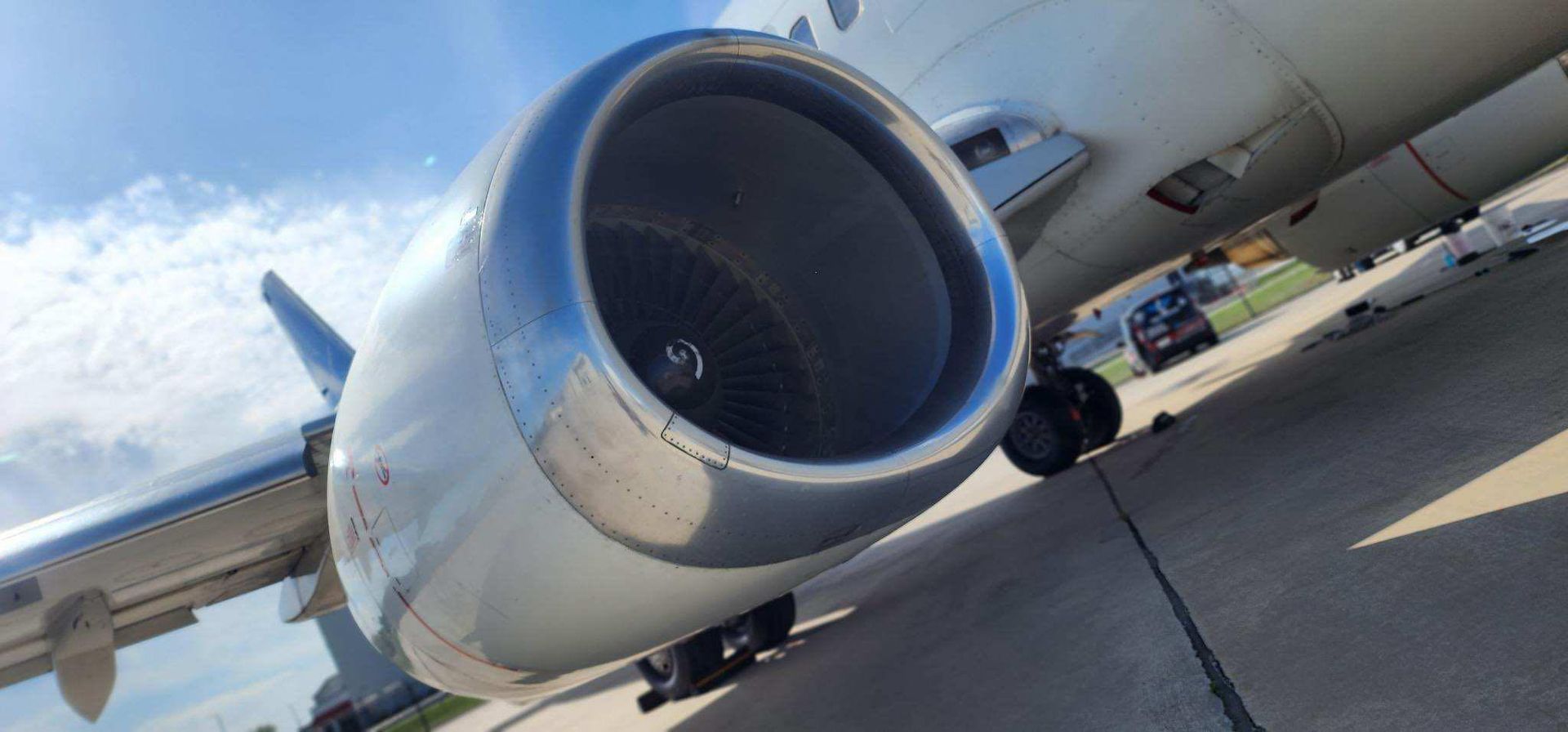 The engine of an airplane is sitting on the runway.