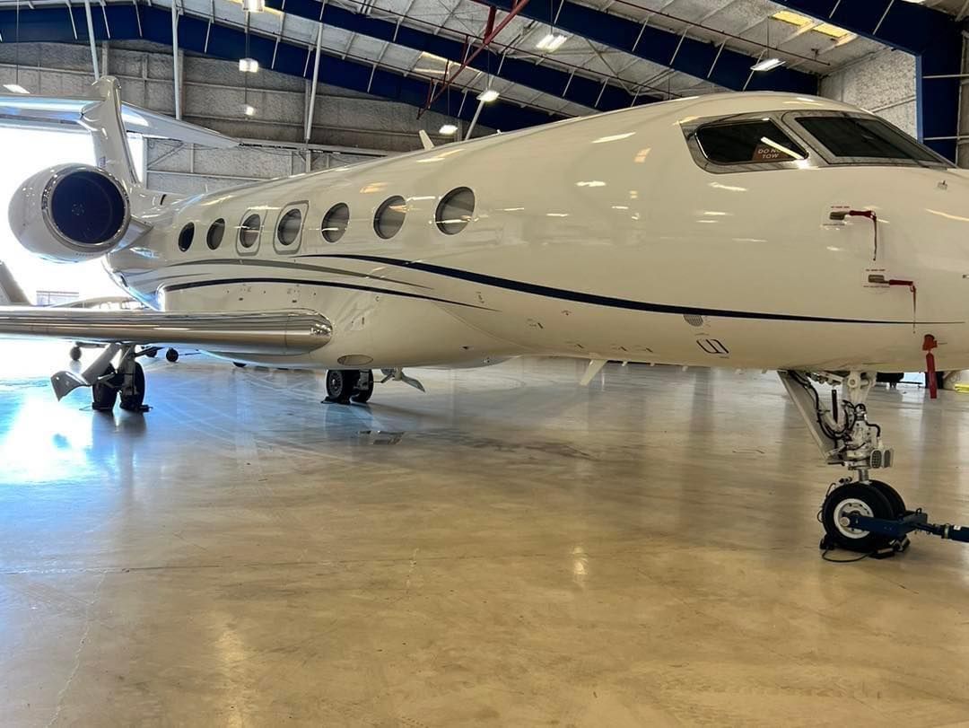 A small private jet is parked in a hangar.