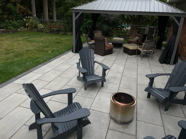 a patio with chairs and a gazebo in the background