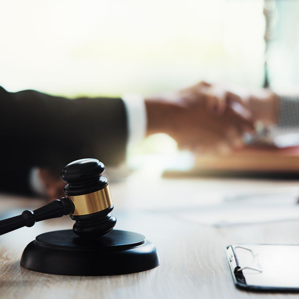 A family is walking down a wooden walkway holding hands.