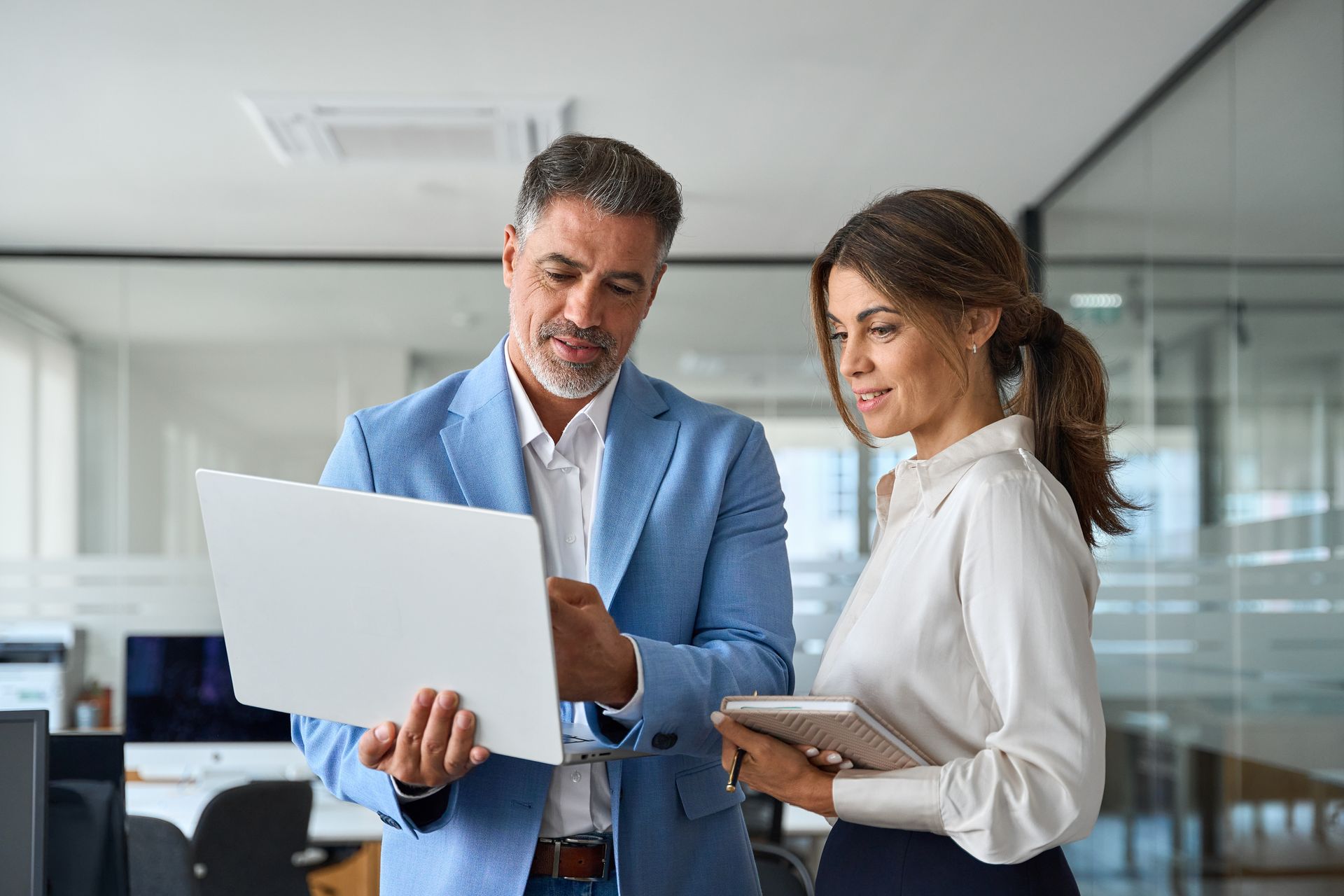 A city skyline overlooking a body of water at night.