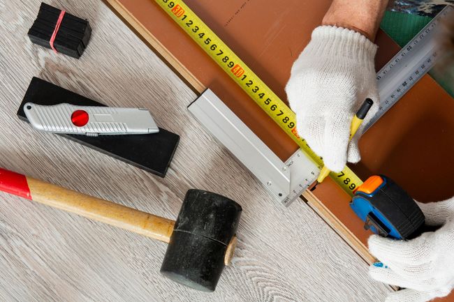 Man Measures the New Wood Floor — Lynnwood, WA — Fuentes Hardwood Floors