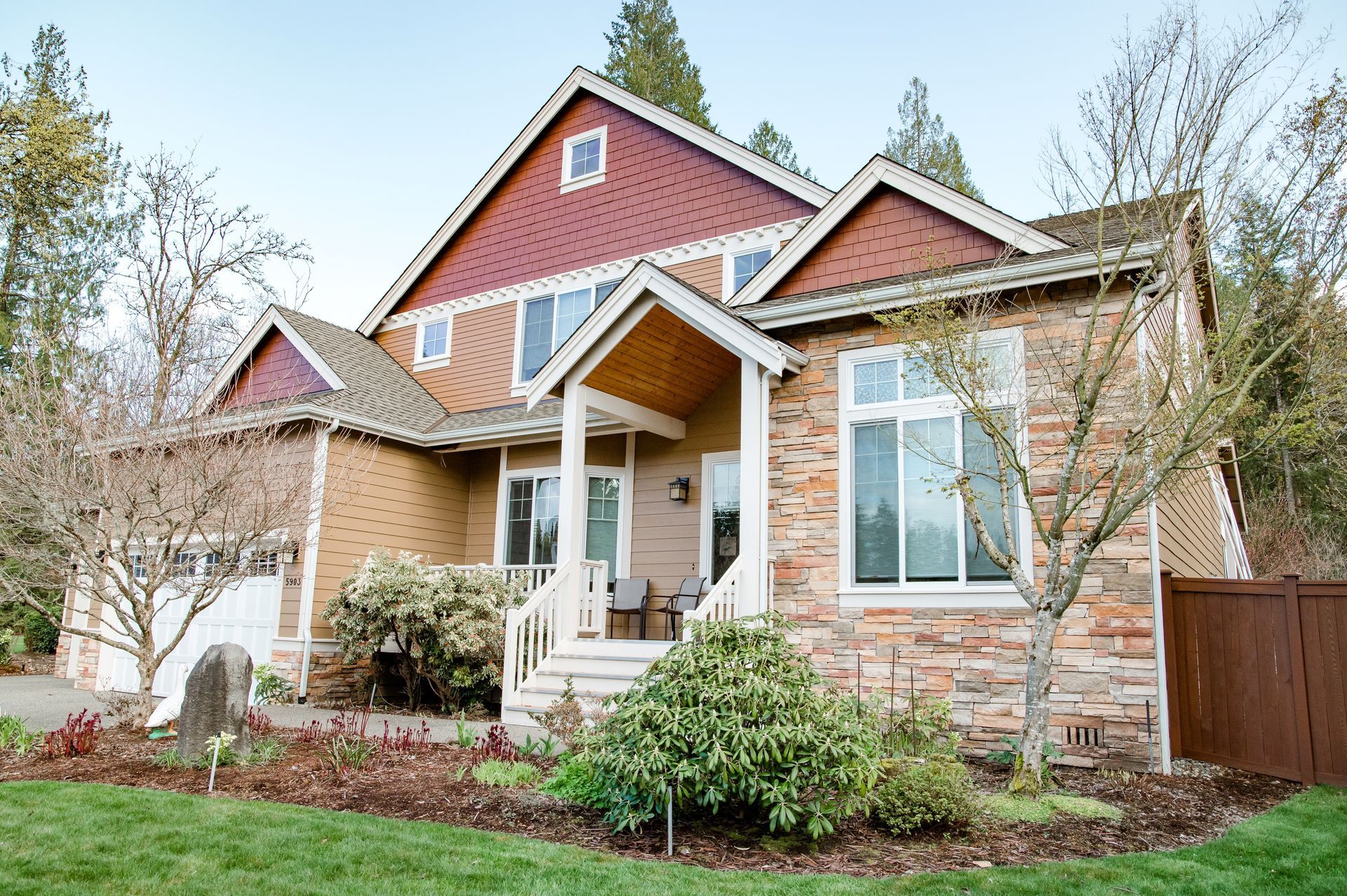 A large house with a porch and a lot of windows