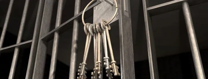 Keys hanging on a jail cell door.