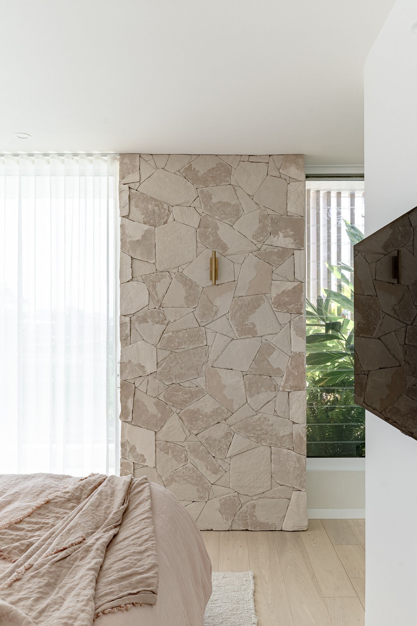 Bedroom With Beige Stone Accent Wall — SDC Building Design In Kiama, NSW