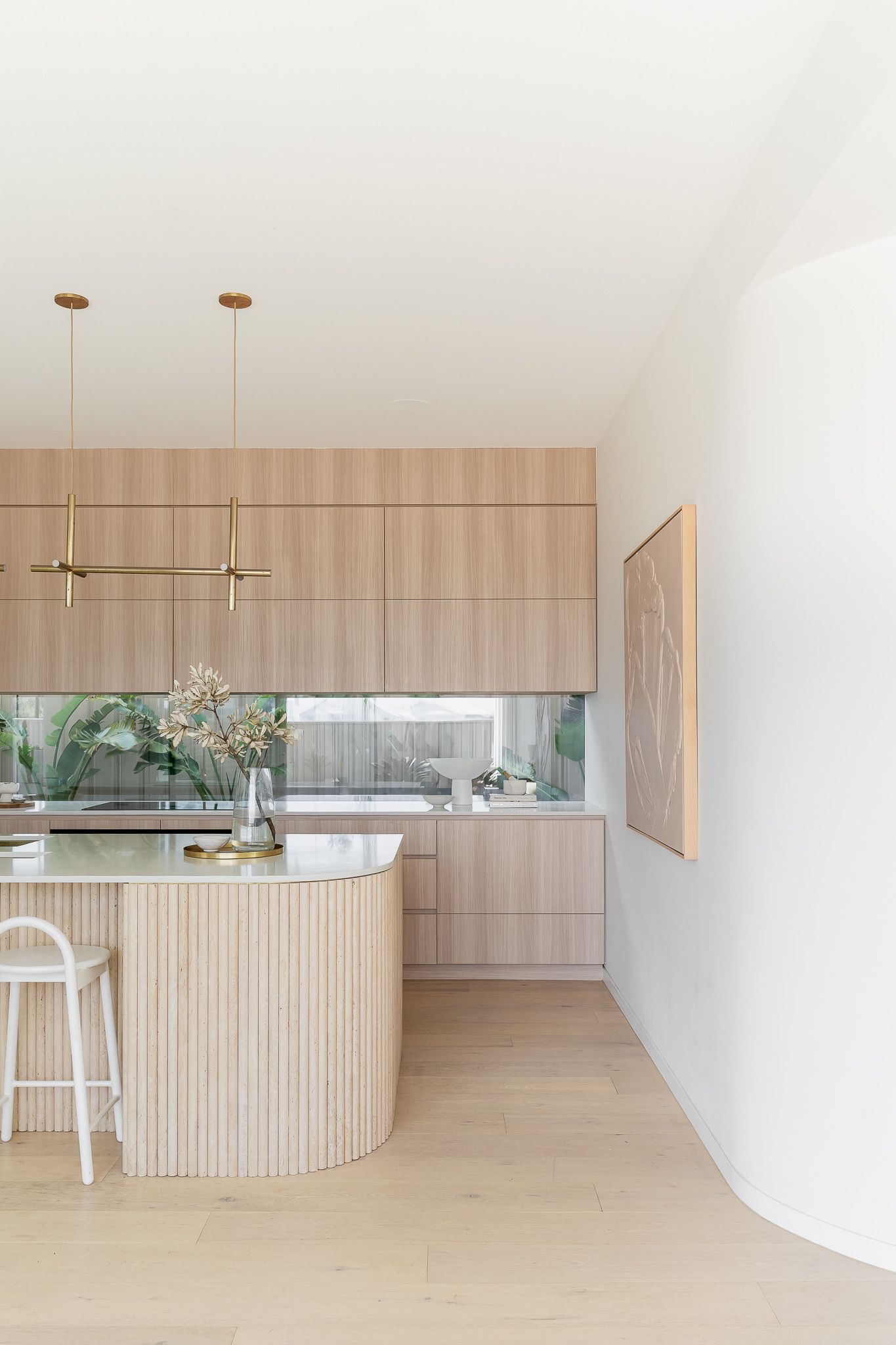 Modern Kitchen With Light Wood Cabinetry, Island, and Artwork on a White Wall — SDC Building Design In Kiama, NSW