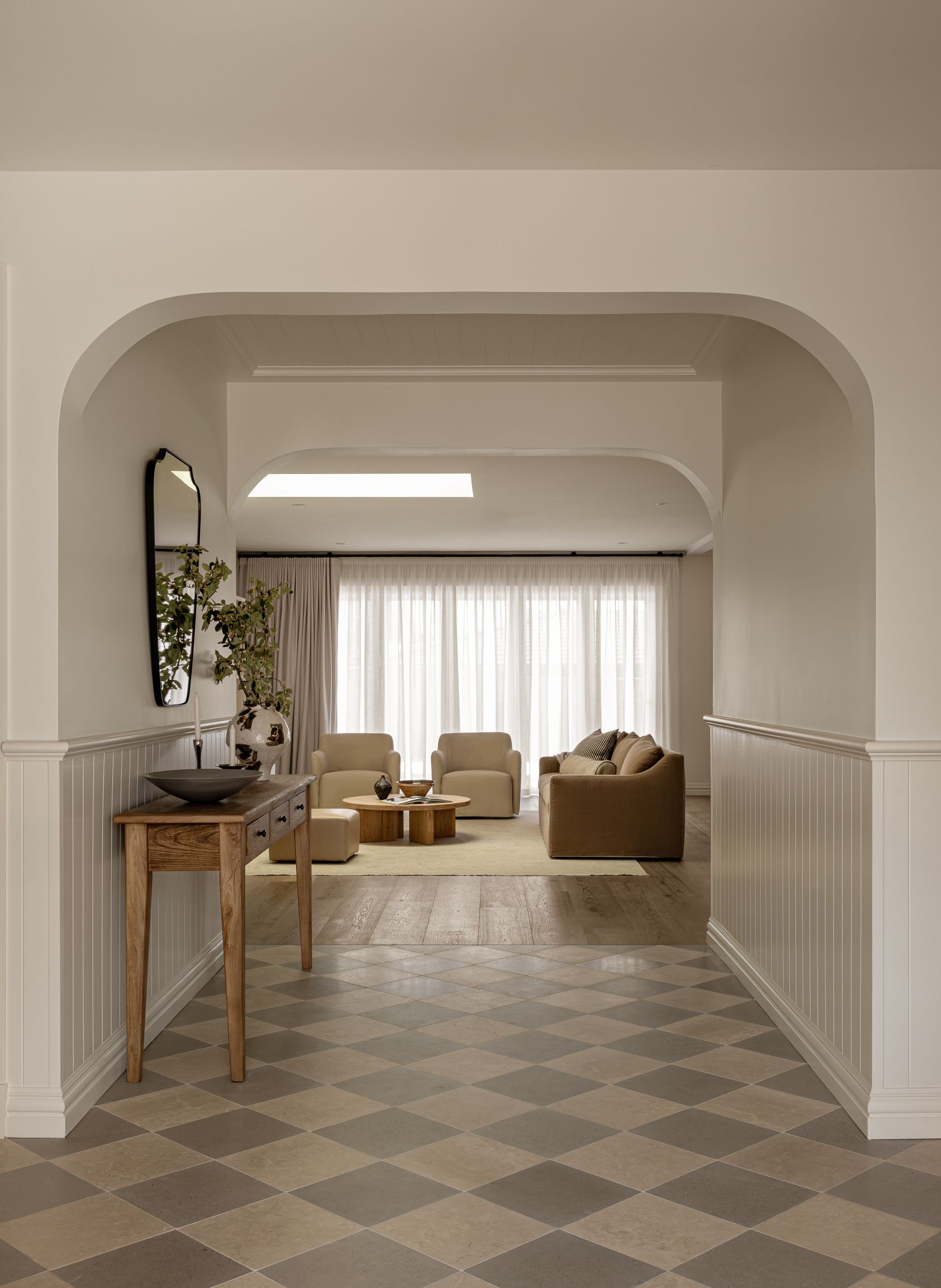 A Hallway With Diamond-patterned Tile Leads to a Living Room — SDC Building Design In Kiama, NSW