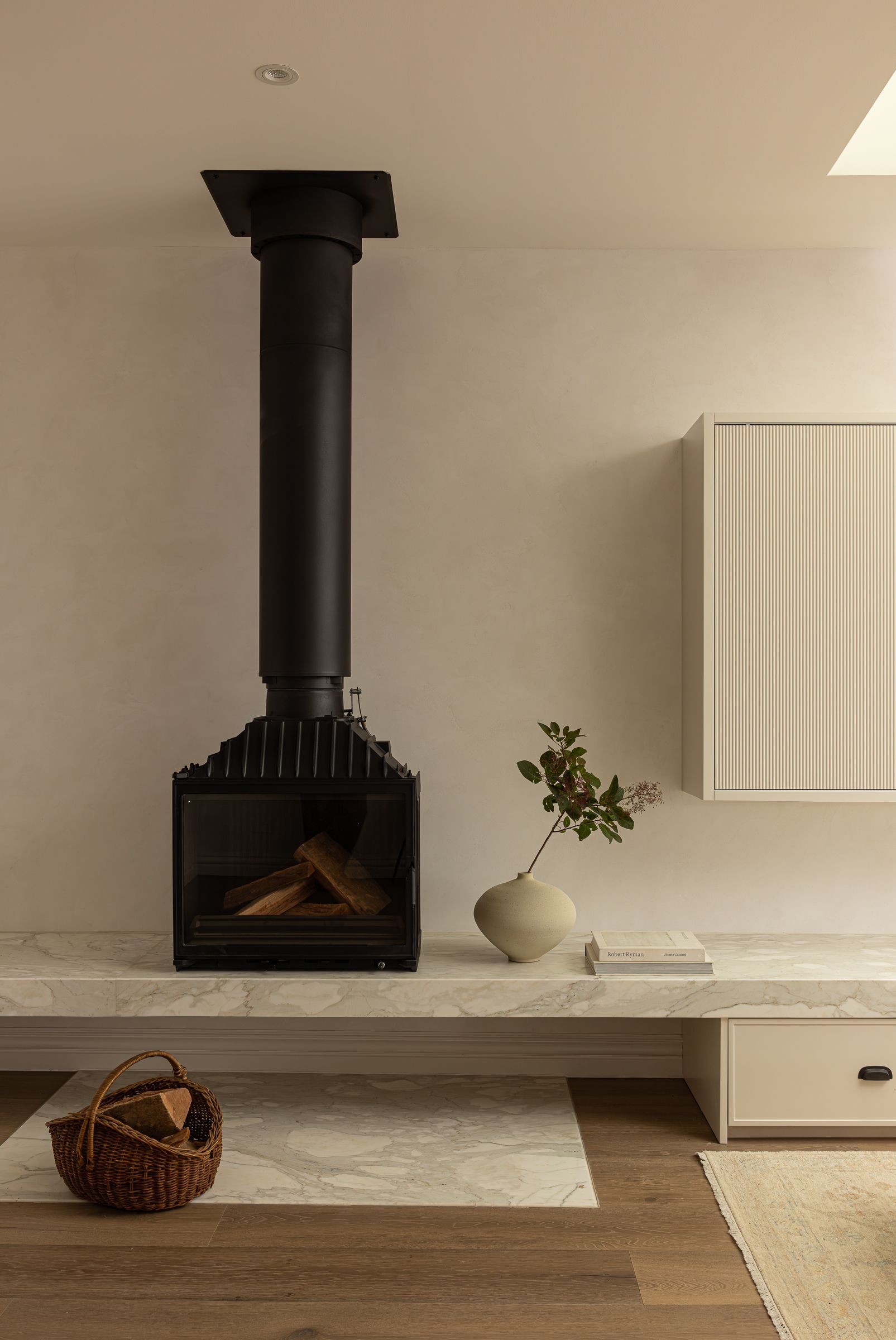 Black Fireplace Hanging From Ceiling, Above a Marble Hearth — SDC Building Design In Kiama, NSW
