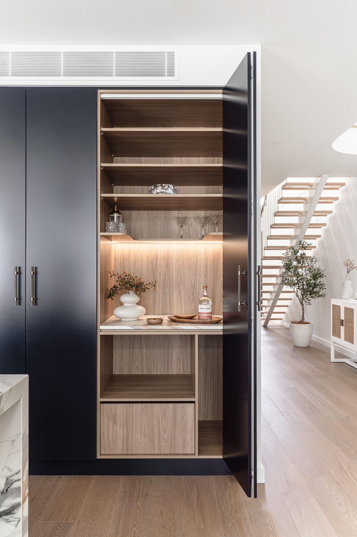 Dark Blue Cabinet With an Open, Illuminated, Wooden Shelf Interior — SDC Building Design In Kiama, NSW