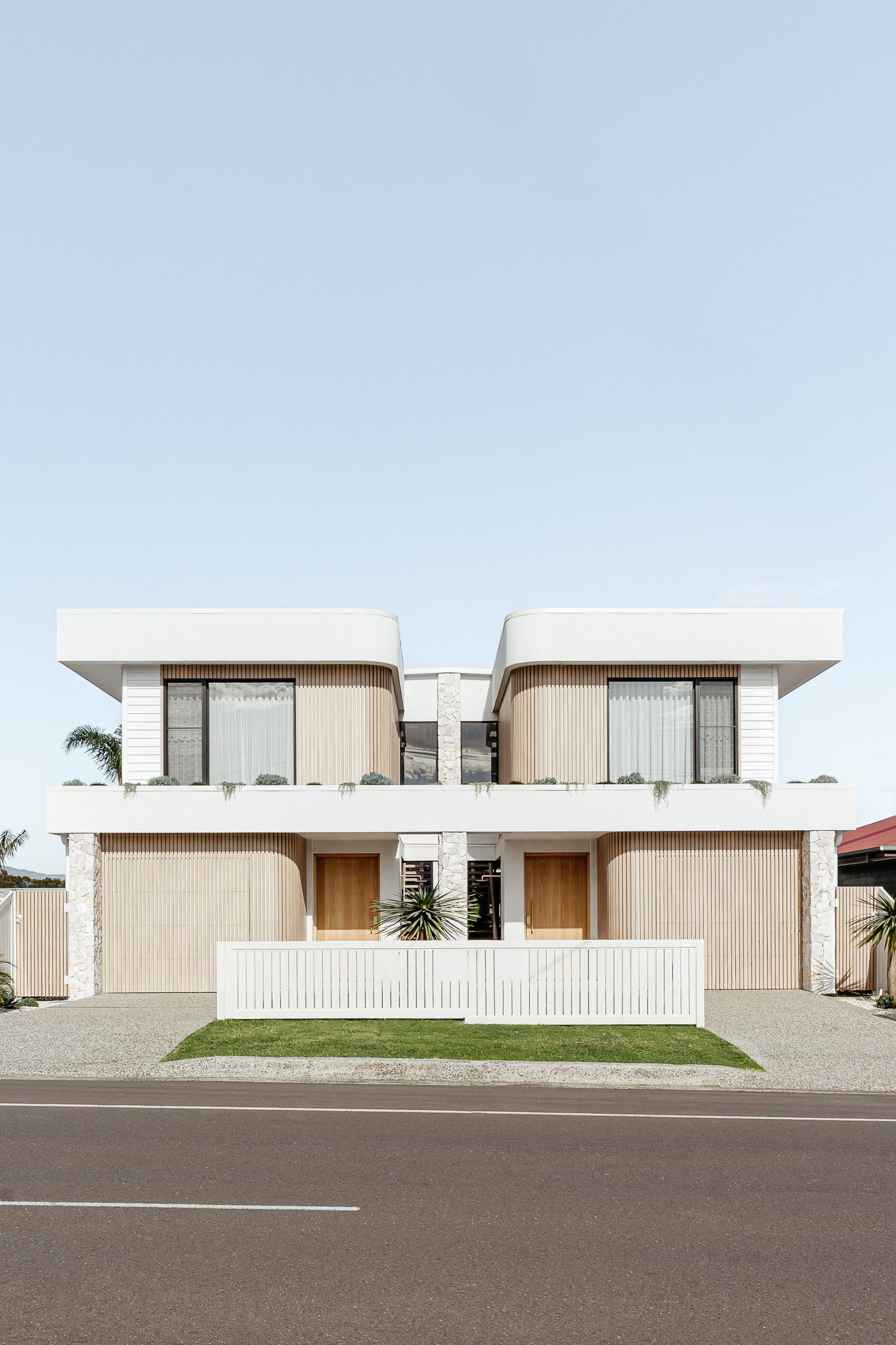 Two Modern, White and Wood-toned, Symmetrical Houses With a Shared Central Entry — SDC Building Design In Kiama, NSW