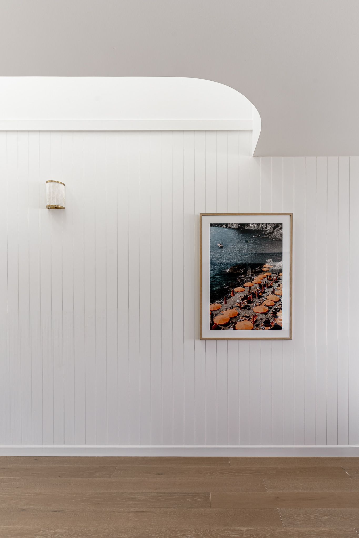 White Paneled Wall With a Framed Photo and a Sconce — SDC Building Design In Kiama, NSW
