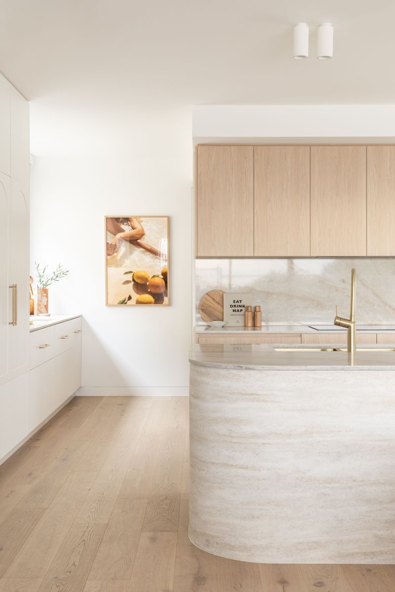 Modern kitchen with wooden cabinets, light countertops, and curved island. — SDC Building Design In Kiama, NSW