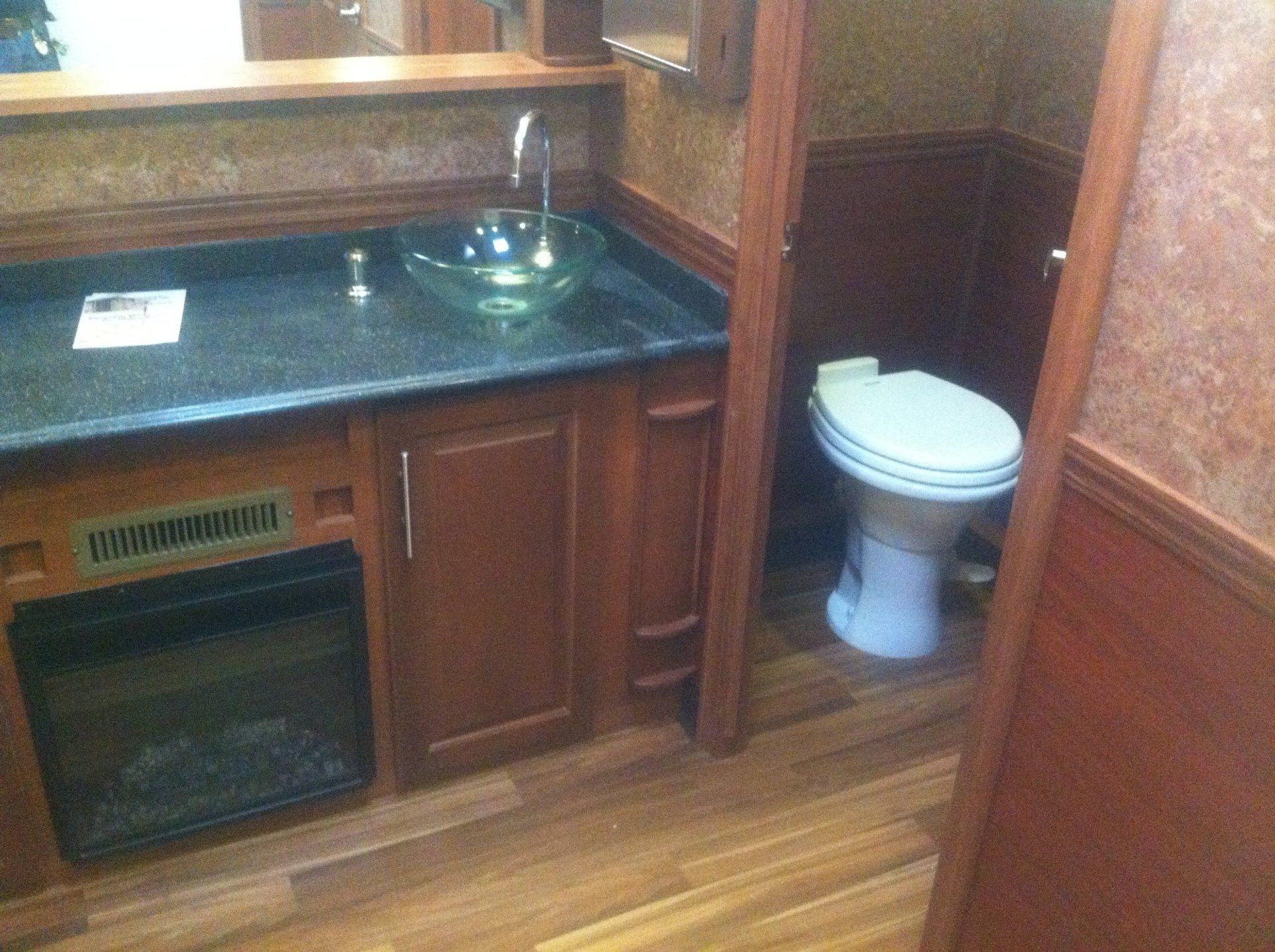 A bathroom with a sink , toilet and mirror.
