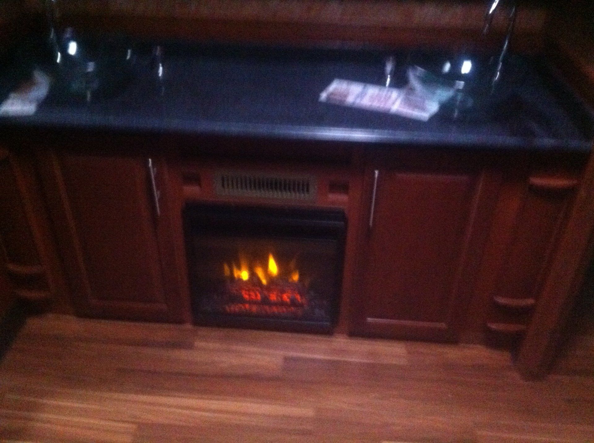 A kitchen with a fireplace built into the cabinets