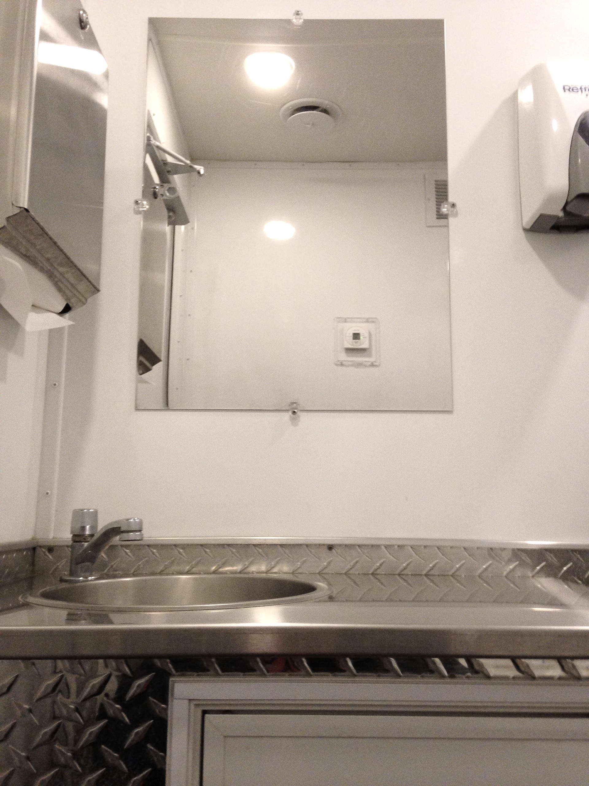 A bathroom with a sink and a mirror on the wall