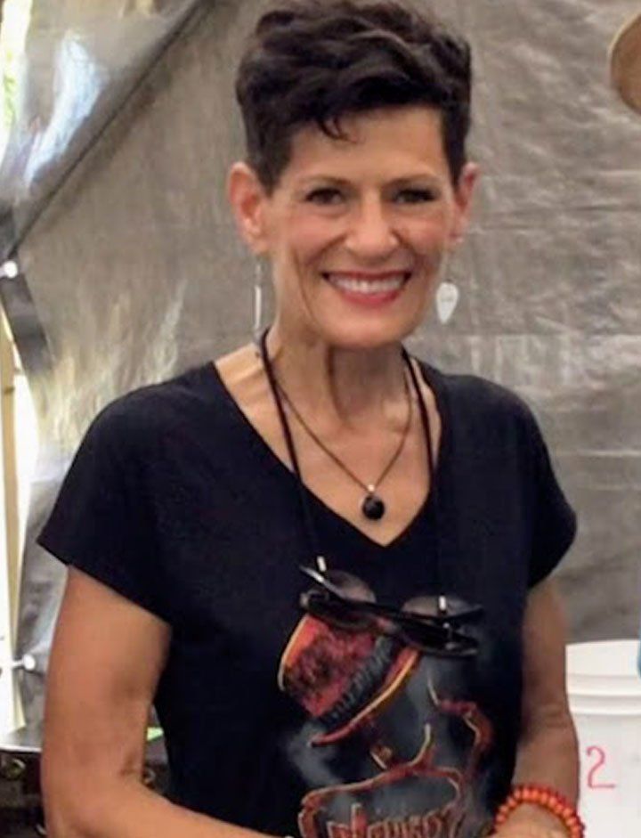 A woman wearing a black shirt with a skull on it