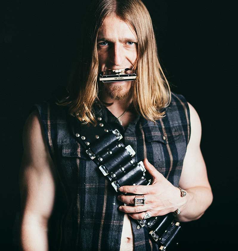 will wilde with harp in mouth and bandolier