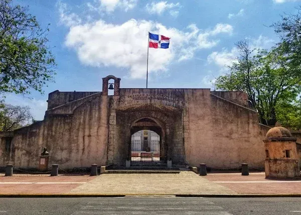 Stone archway with Dominican Republic flag waving.