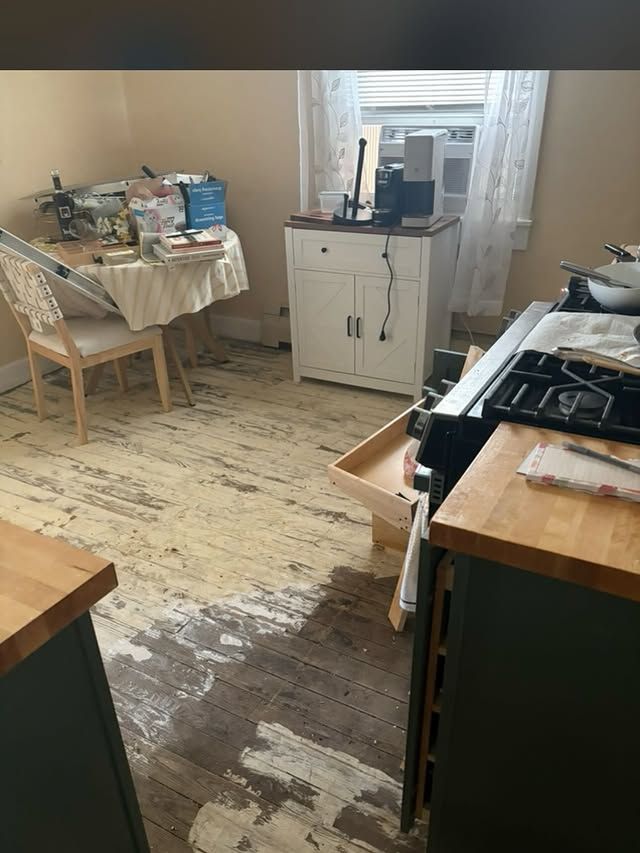 a kitchen under construction with a large island in the middle .