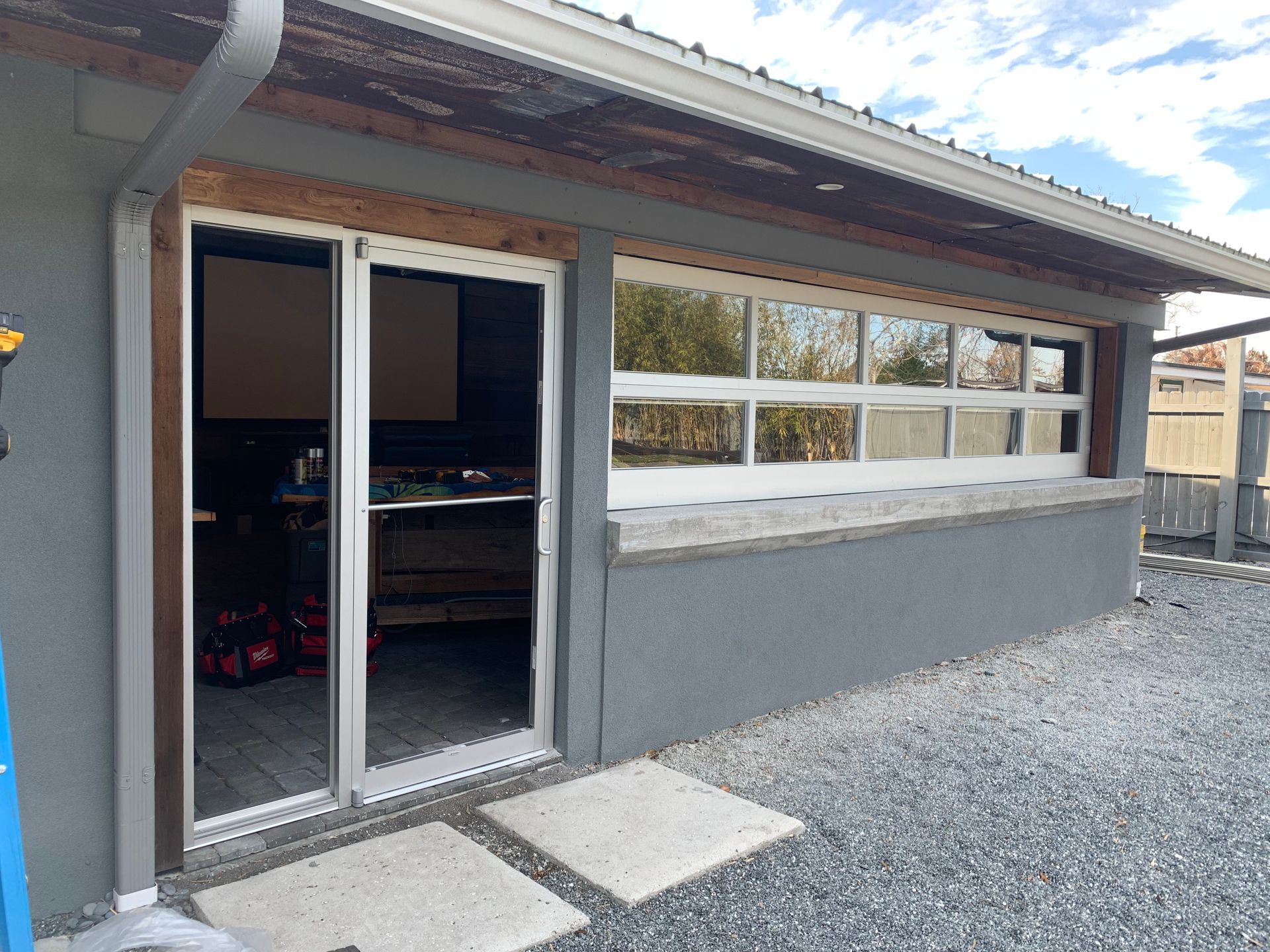 A house with a lot of windows and a sliding glass door