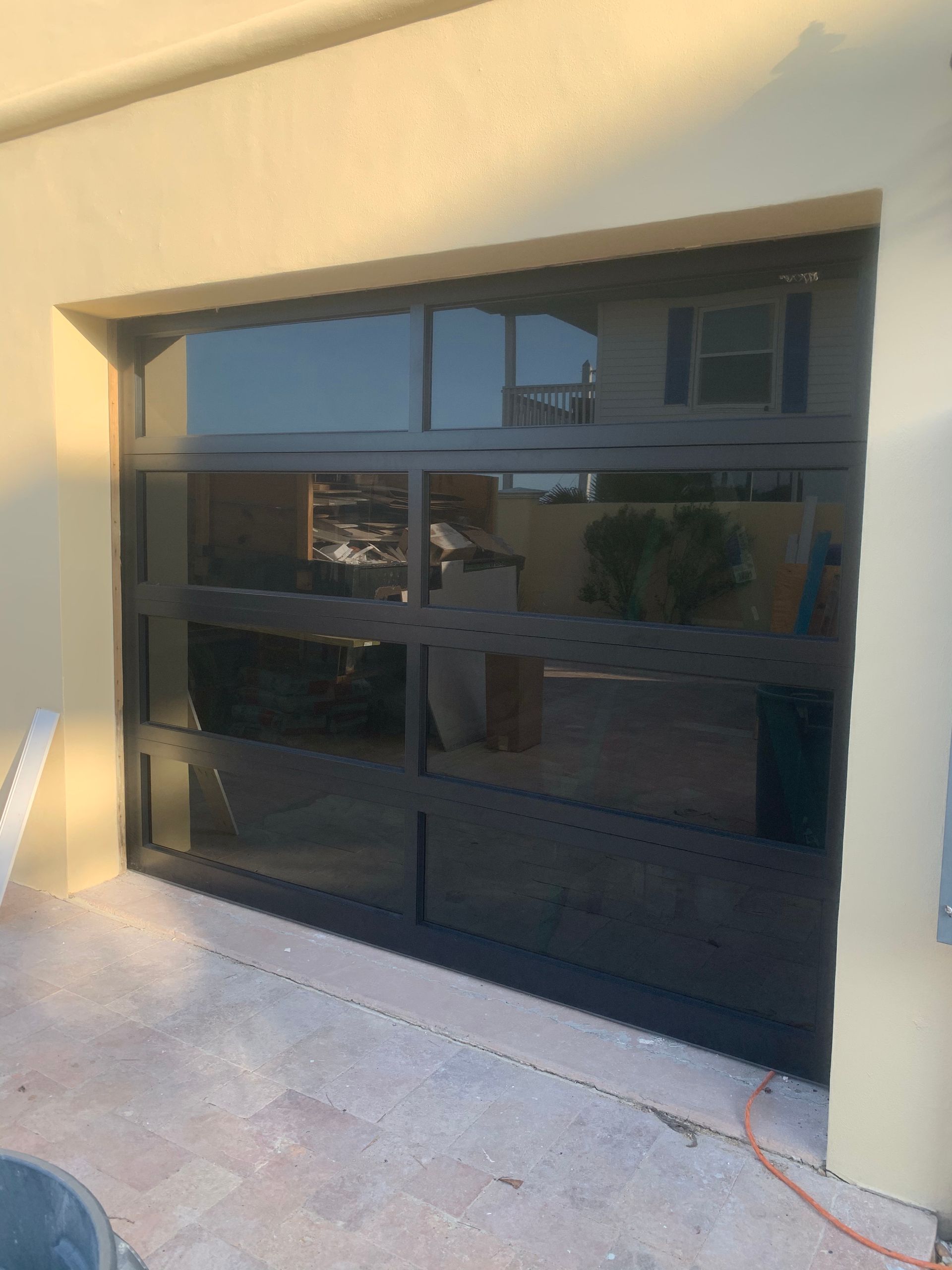 A black garage door with a lot of windows