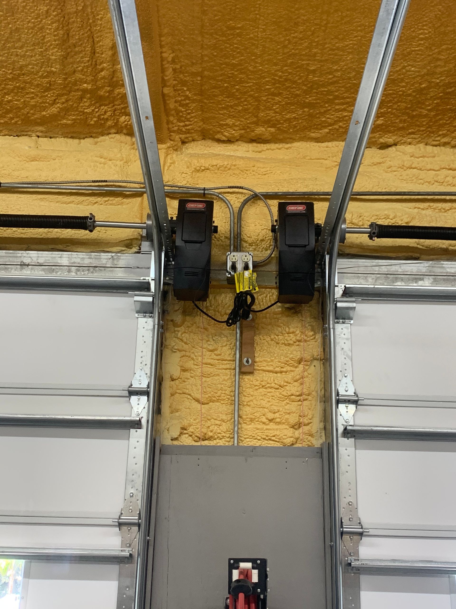 A close up of a garage door with a motor attached to it.