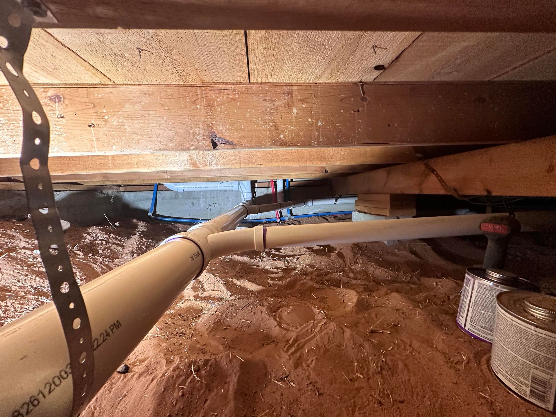 A chain is hanging from a pipe in a basement