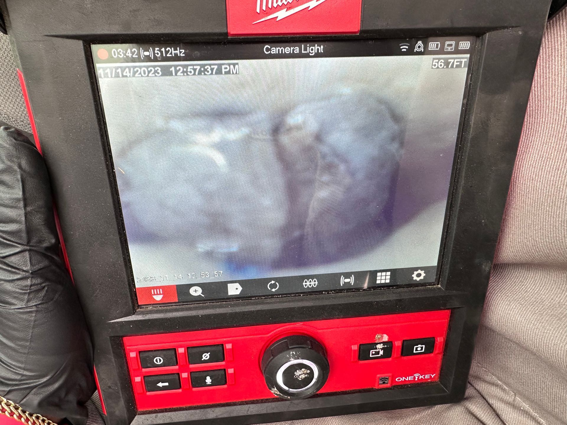 A red and black device with a screen that says milwaukee on it