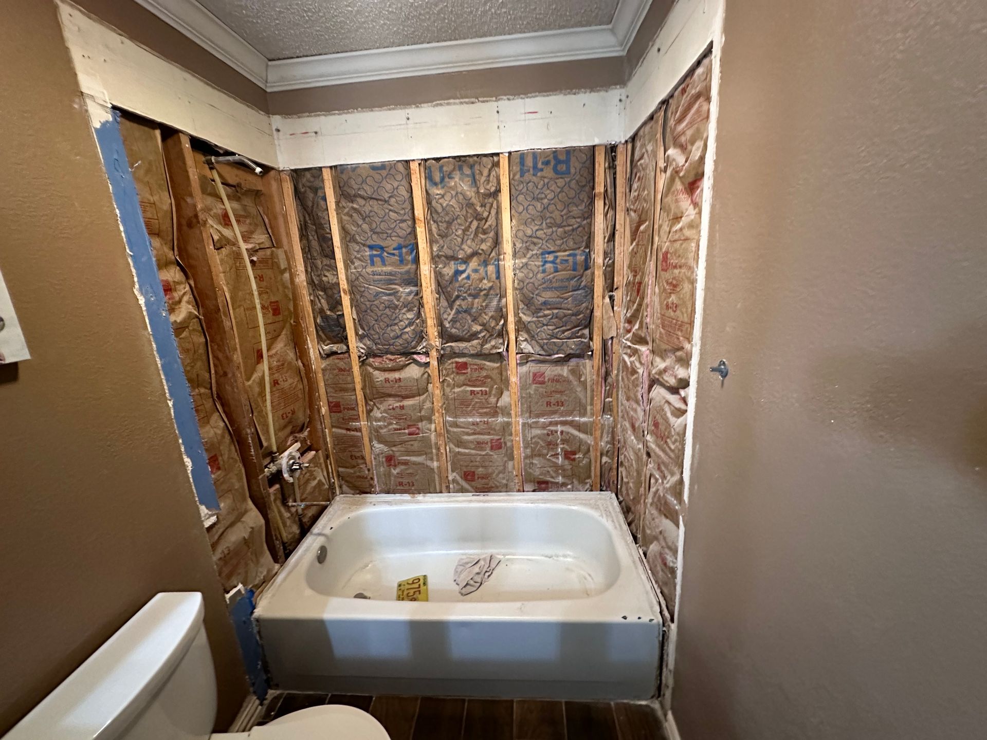 A bathroom with a bathtub and toilet under construction