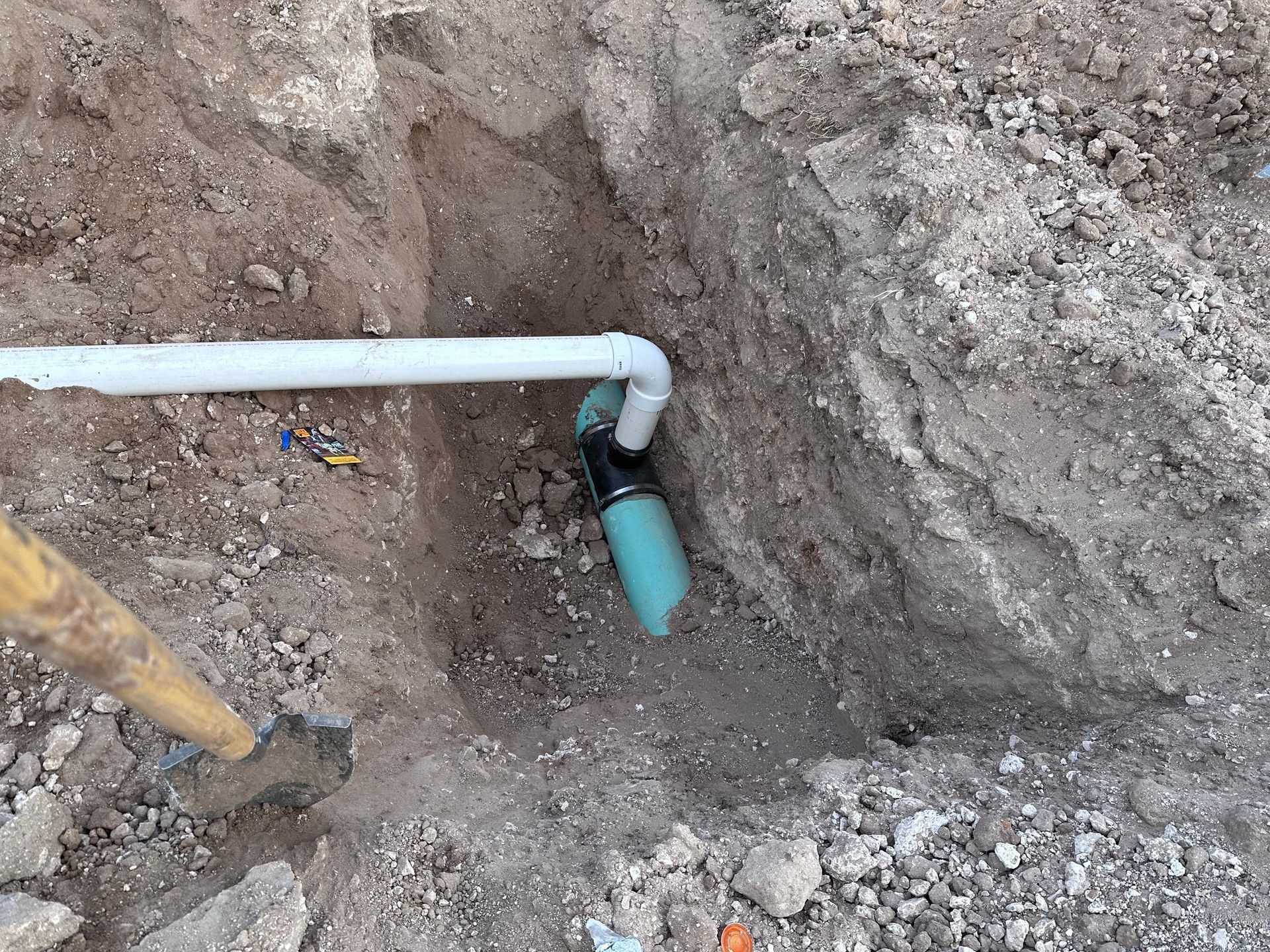 A pipe is being installed in a hole in the ground.
