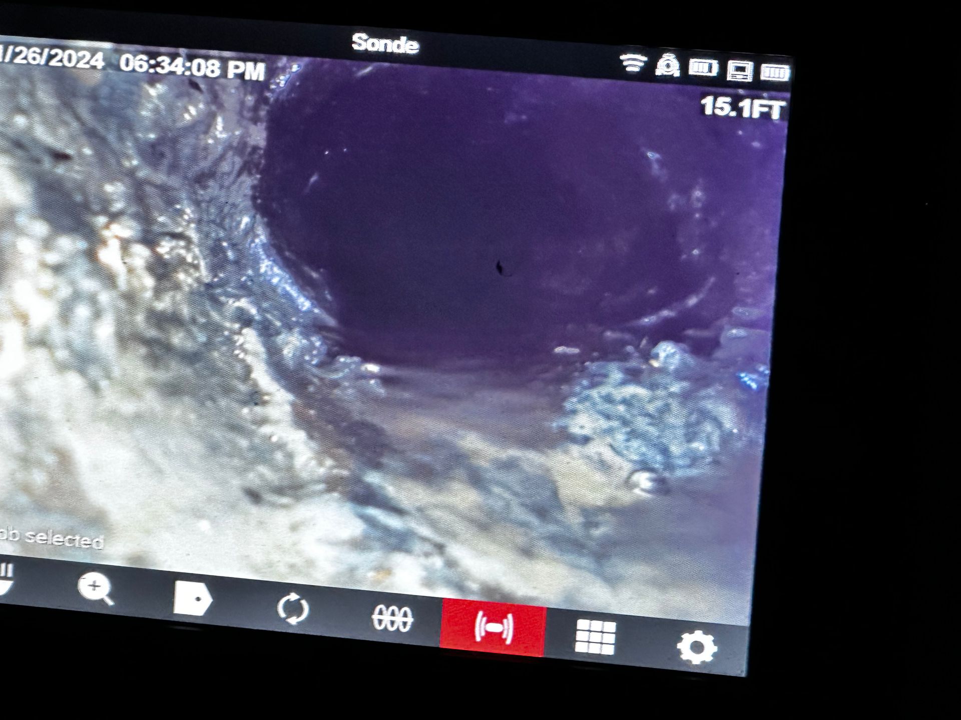 A screen shows a hole in the ground and the time is 6:34 pm