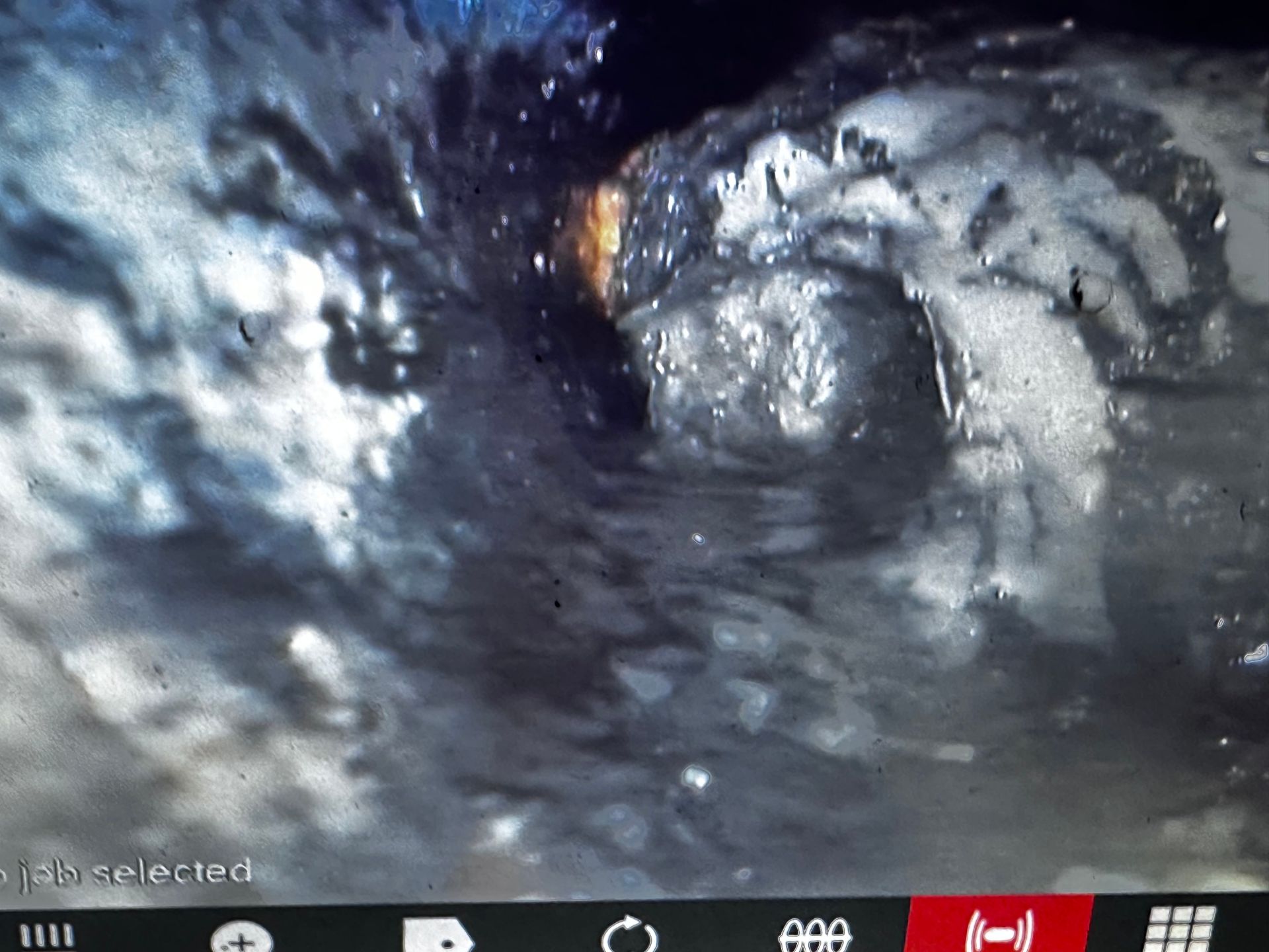 A computer screen shows a picture of a hole in the ground