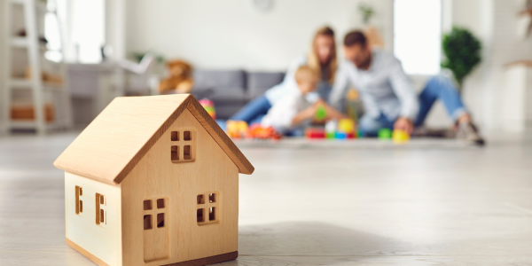 oy house on floor with family in background representing common home insurance claim scenarios