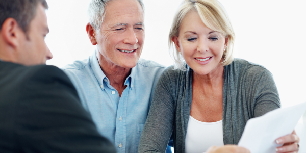 Smiling senior couple meeting with a financial advisor about annuities