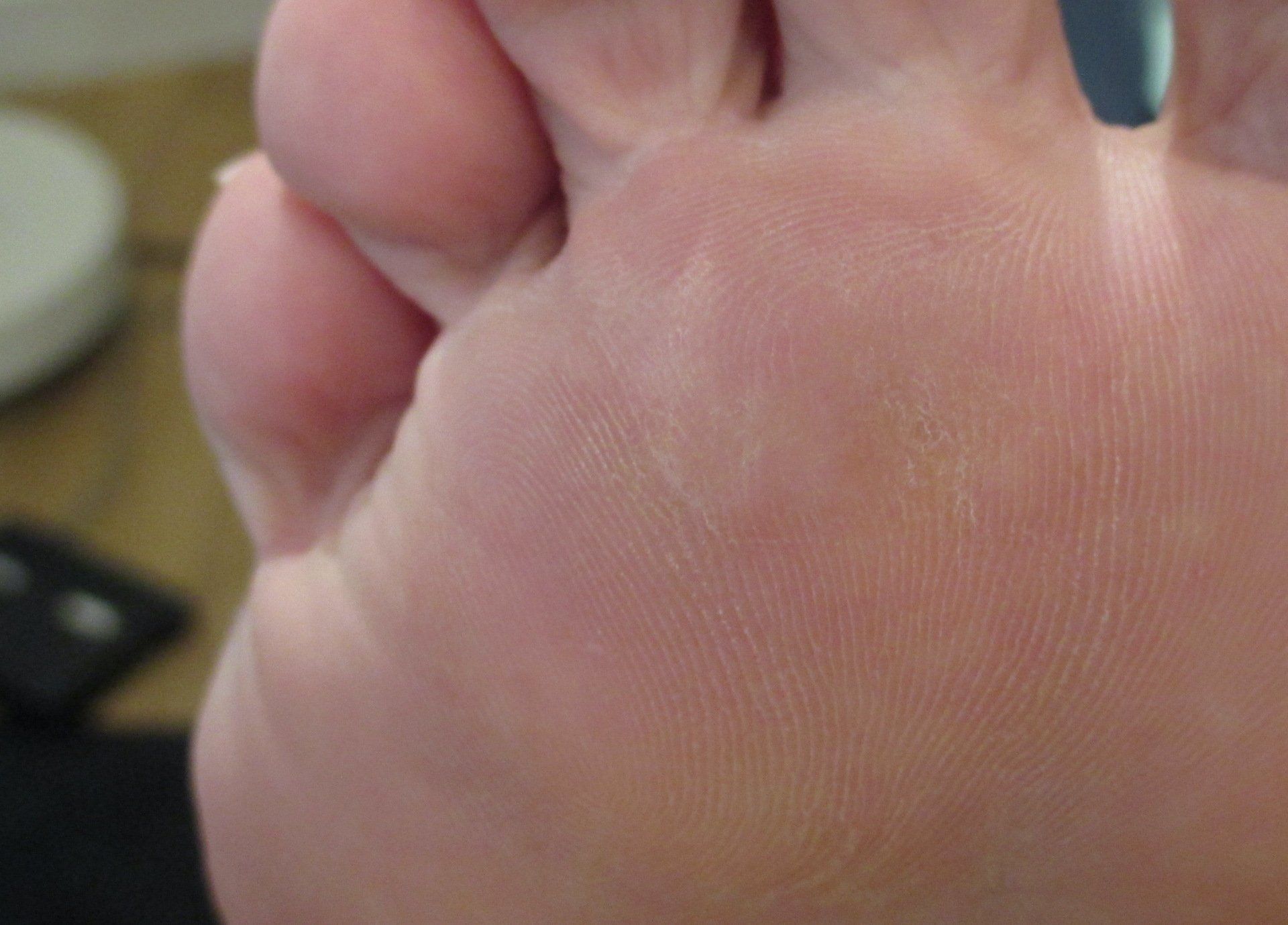 A close up of a person 's foot on a table.